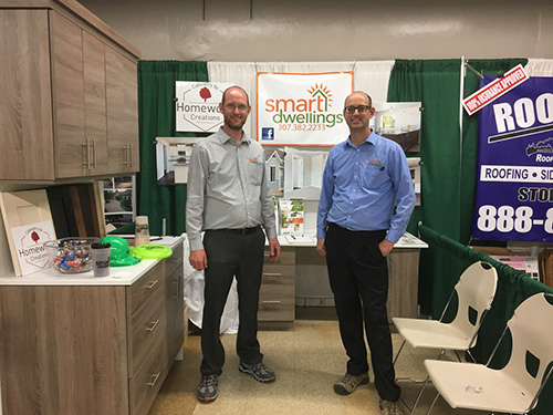 Image of two brothers  - the owners of smart dwellings, at the home and garden show with their booth>